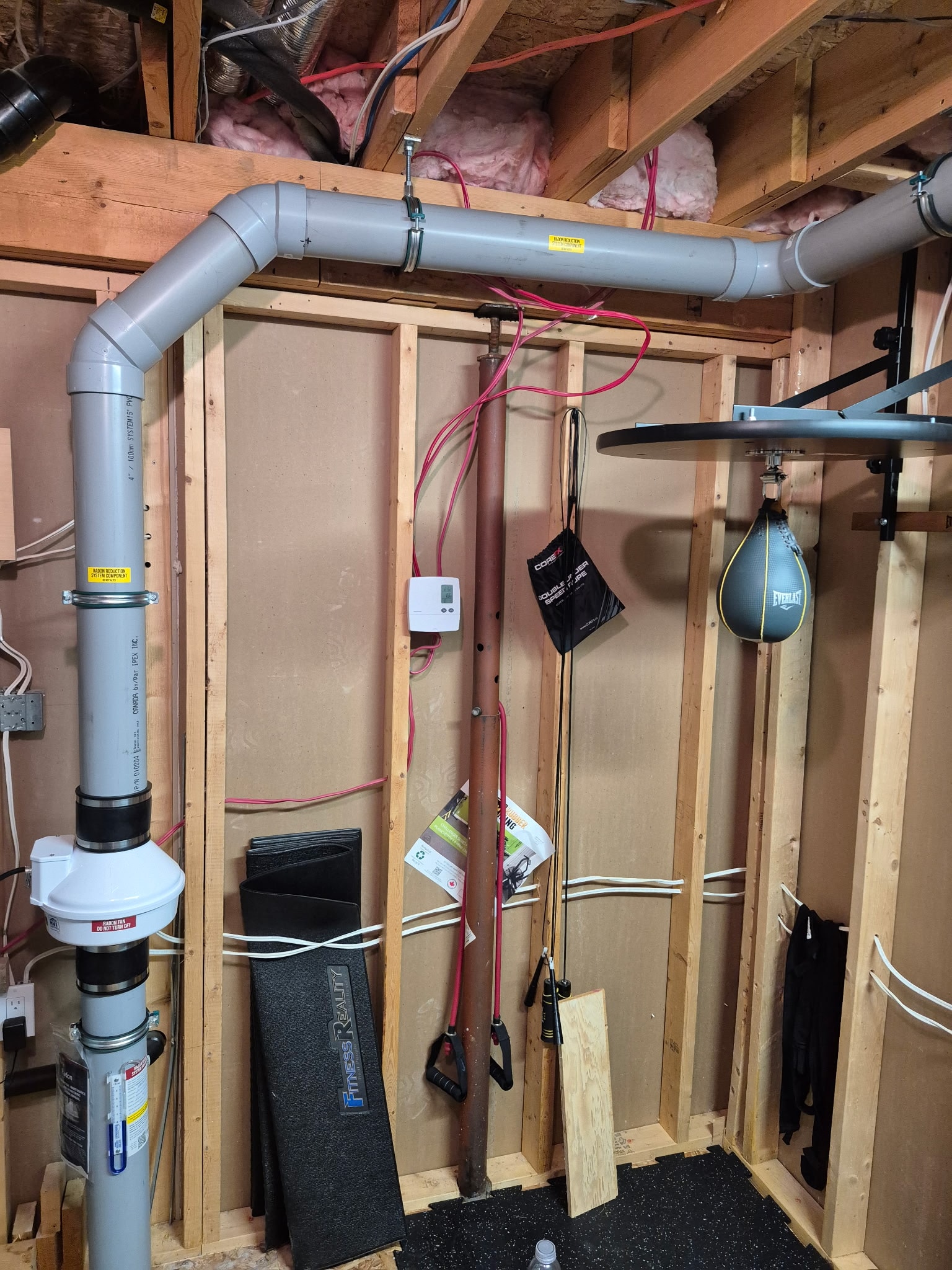 Radon mitigation system with PVC pipe installed in basement – Radon Plus New Brunswick